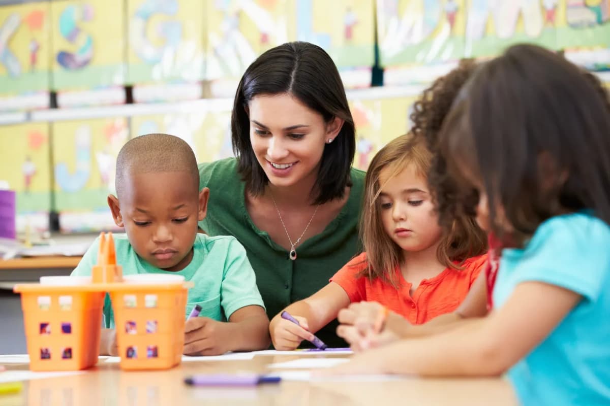 Teacher helping students in an English classroom